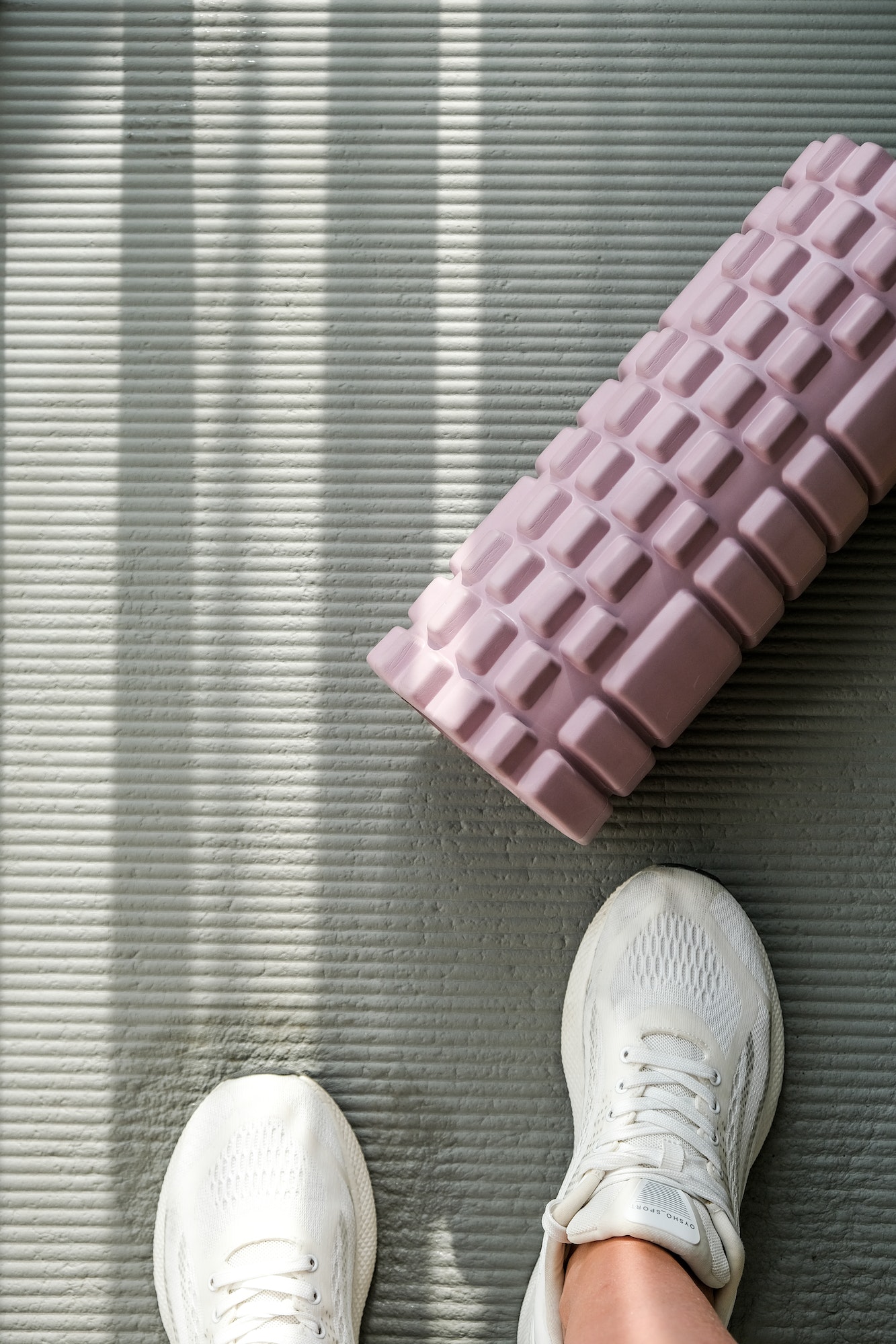 Fitness, roll on the fitness mat for myofascial release. Fascia massage, wellness, health, sports